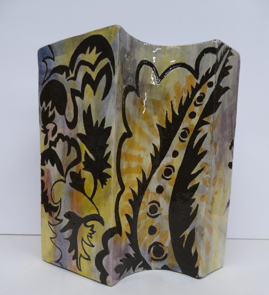 Image of Vivienne Burns' ceramic piece "Landscape 1", featuring black clay, slips, underglaze colours and glaze. 