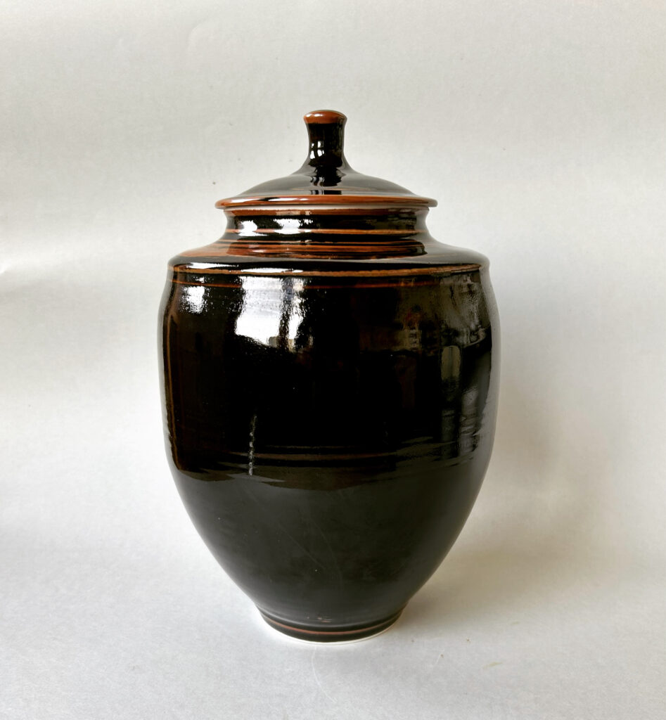 A dark brown glazed porcelain Tenmoku Lidded Vessel by Harvey Bradley.